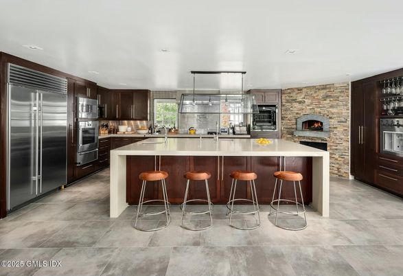 Fireplace, Interior, Kitchen, Recessed Lighting, Stainless Steel Appliances, Stone Walls