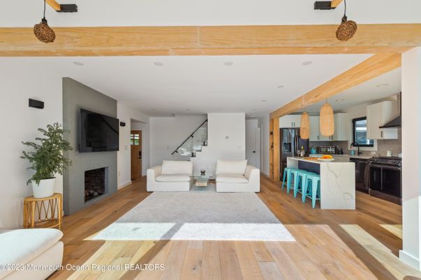 Fireplace, Interior, Kitchen, Living room, Pendant Lights, Recessed Lighting, Stainless Steel Appliances, Wooden Beams, Wood Texture Flooring