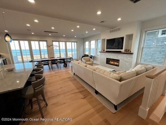 Dining room, Fireplace, Interior, Living room, Pendant Lights, Recessed Lighting, Water, Wood Texture Flooring