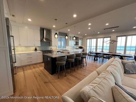 Dining room, Interior, Kitchen, Living room, Pendant Lights, Recessed Lighting, Stainless Steel Appliances, Water, Wood Texture Flooring