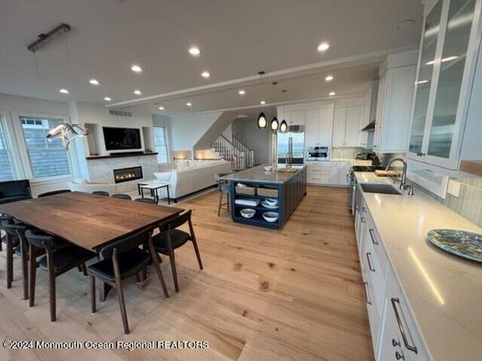 Dining room, Fireplace, Interior, Kitchen, Living room, Pendant Lights, Recessed Lighting, Stainless Steel Appliances, Wood Texture Flooring