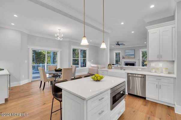 Chandelier, Dining room, Fireplace, Interior, Kitchen, Living room, Pendant Lights, Recessed Lighting, Stainless Steel Appliances, Wood Texture Flooring
