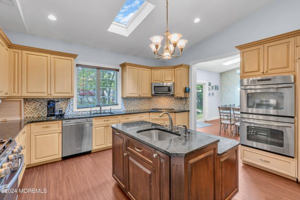Chandelier, Dining room, Interior, Kitchen, Recessed Lighting, Stainless Steel Appliances, Wood Texture Flooring