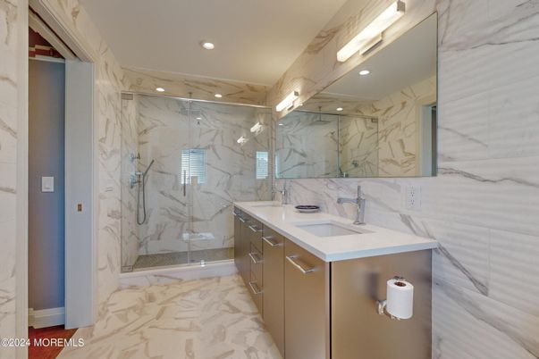 Bathroom, Dual Sink Vanities, Glass Shower, Interior, Marble, Marble Walls, Recessed Lighting