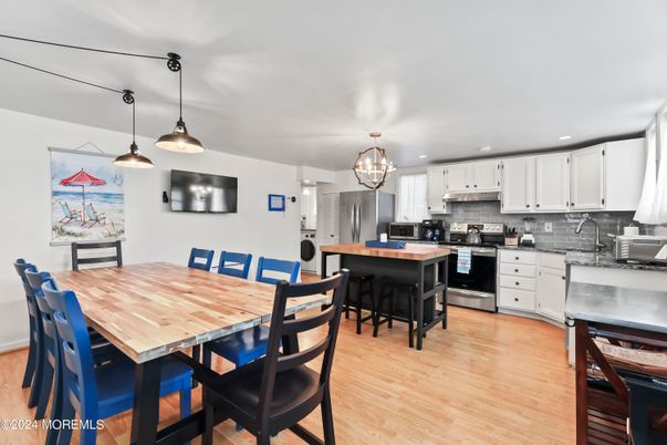 Chandelier, Dining room, Interior, Kitchen, Pendant Lights, Recessed Lighting, Stainless Steel Appliances, Wood Texture Flooring