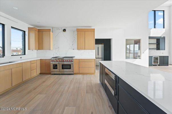 Interior, Kitchen, Marble Walls, Recessed Lighting, Stainless Steel Appliances, Wood Texture Flooring