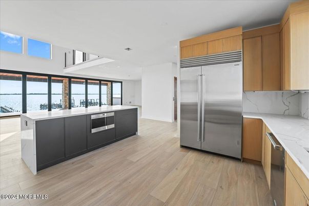 Interior, Kitchen, Marble Walls, Recessed Lighting, Stainless Steel Appliances, Wood Texture Flooring
