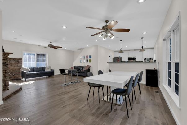 Dining room, Fireplace, Interior, Kitchen, Living room, Pendant Lights, Recessed Lighting, Stainless Steel Appliances, Stone Walls, Wood Texture Flooring