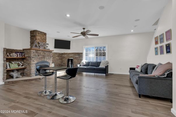 Fireplace, Interior, Living room, Recessed Lighting, Stone Walls, Wood Texture Flooring