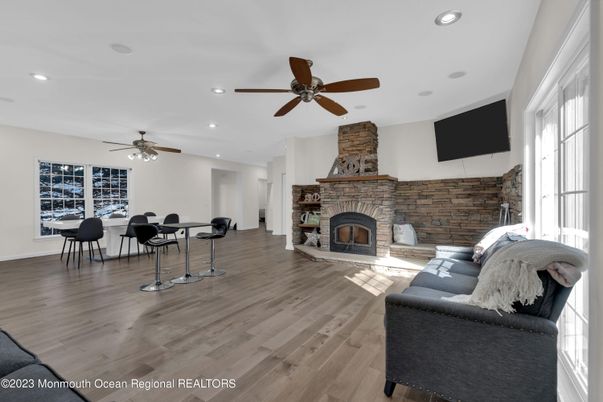 Dining room, Fireplace, Interior, Living room, Recessed Lighting, Stone Walls, Wood Texture Flooring
