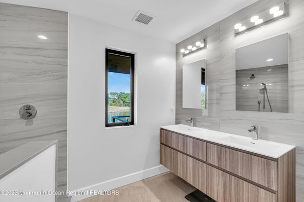 Bathroom, Dual Sink Vanities, Interior, Marble Walls, Recessed Lighting, Wood Texture Flooring