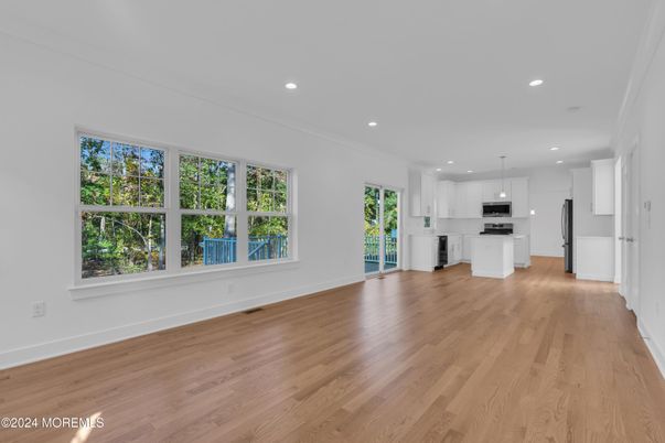 Empty room, Interior, Kitchen, Pendant Lights, Recessed Lighting, Stainless Steel Appliances, Wood Texture Flooring