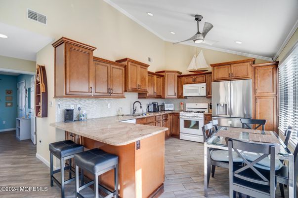 Dining room, Interior, Kitchen, Recessed Lighting, Stainless Steel Appliances, Wood Texture Flooring