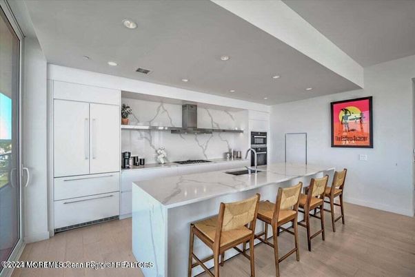 Interior, Kitchen, Marble Walls, Recessed Lighting, Stainless Steel Appliances, Wood Texture Flooring