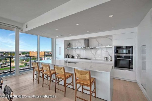 Interior, Kitchen, Marble Walls, Recessed Lighting, Stainless Steel Appliances, Wood Texture Flooring