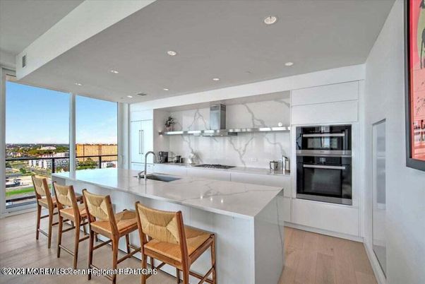 Interior, Kitchen, Marble Walls, Recessed Lighting, Stainless Steel Appliances, Wood Texture Flooring