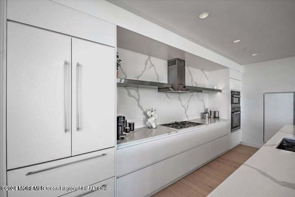 Interior, Kitchen, Marble Walls, Recessed Lighting, Stainless Steel Appliances, Wood Texture Flooring