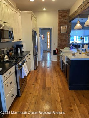 Interior, Kitchen, Pendant Lights, Recessed Lighting, Stainless Steel Appliances, Stone Walls, Wood Texture Flooring