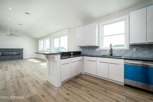 Fireplace, Interior, Kitchen, Recessed Lighting, Stainless Steel Appliances, Wood Texture Flooring