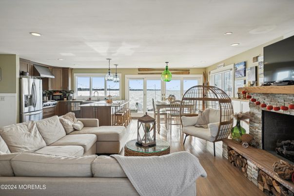 Chandelier, Dining room, Fireplace, Interior, Kitchen, Living room, Pendant Lights, Recessed Lighting, Stainless Steel Appliances, Wood Texture Flooring