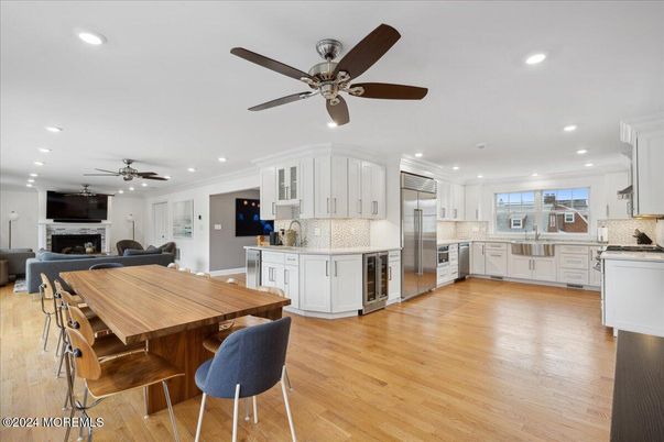 Dining room, Fireplace, Interior, Kitchen, Recessed Lighting, Stainless Steel Appliances, Wood Texture Flooring