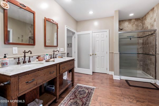 Bathroom, Dual Sink Vanities, Glass Shower, Interior, Recessed Lighting, Wood Texture Flooring