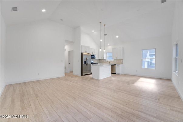 Empty room, Interior, Kitchen, Pendant Lights, Recessed Lighting, Stainless Steel Appliances, Wood Texture Flooring