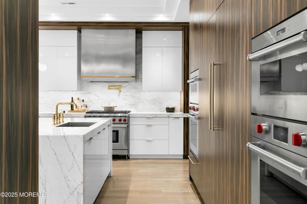 Interior, Kitchen, Marble Walls, Recessed Lighting, Stainless Steel Appliances, Wood Texture Flooring