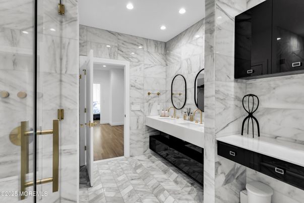 Bathroom, Dual Sink Vanities, Interior, Marble, Marble Walls, Recessed Lighting, Wood Texture Flooring