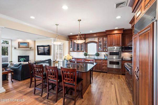 Dining room, Fireplace, Interior, Kitchen, Living room, Pendant Lights, Recessed Lighting, Stainless Steel Appliances, Wood Texture Flooring