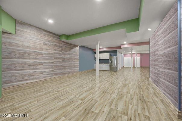 Empty room, Interior, Kitchen, Recessed Lighting, Stainless Steel Appliances, Wood Texture Flooring