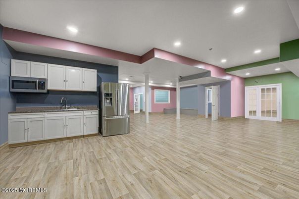 Empty room, Interior, Kitchen, Recessed Lighting, Stainless Steel Appliances, Wood Texture Flooring