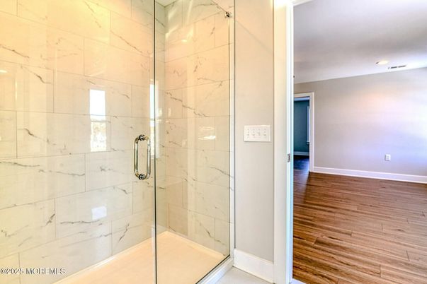 Bathroom, Glass Shower, Interior, Marble Walls, Recessed Lighting, Wood Texture Flooring