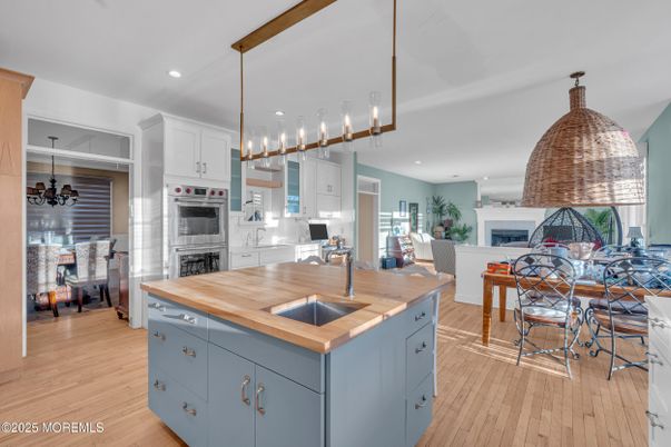 Dining room, Fireplace, Interior, Kitchen, Pendant Lights, Recessed Lighting, Stainless Steel Appliances, Wood Texture Flooring