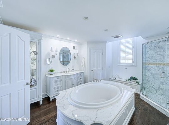 Bathroom, Dual Sink Vanities, Glass Shower, Interior, Marble Walls, Recessed Lighting, Wood Texture Flooring