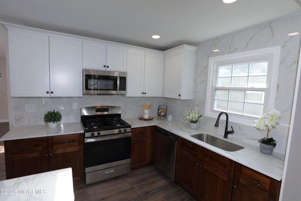 Interior, Kitchen, Marble Walls, Recessed Lighting, Stainless Steel Appliances, Wood Texture Flooring