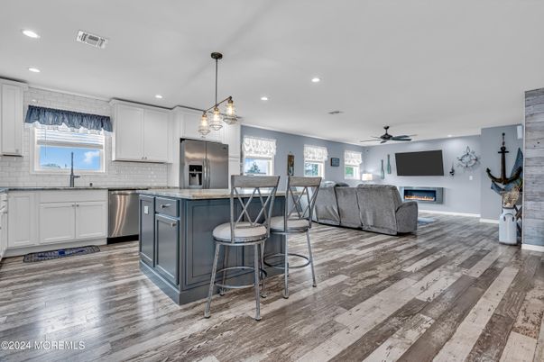 Fireplace, Interior, Kitchen, Living room, Pendant Lights, Recessed Lighting, Stainless Steel Appliances, Wood Texture Flooring