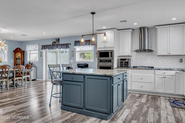 Dining room, Interior, Kitchen, Pendant Lights, Recessed Lighting, Stainless Steel Appliances, Wood Texture Flooring