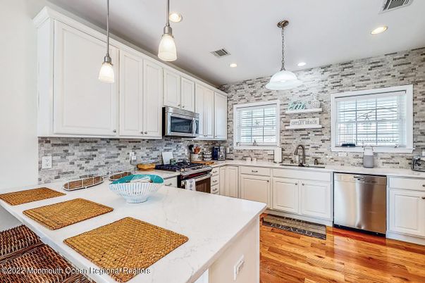 Interior, Kitchen, Pendant Lights, Recessed Lighting, Stainless Steel Appliances, Stone Walls, Wood Texture Flooring