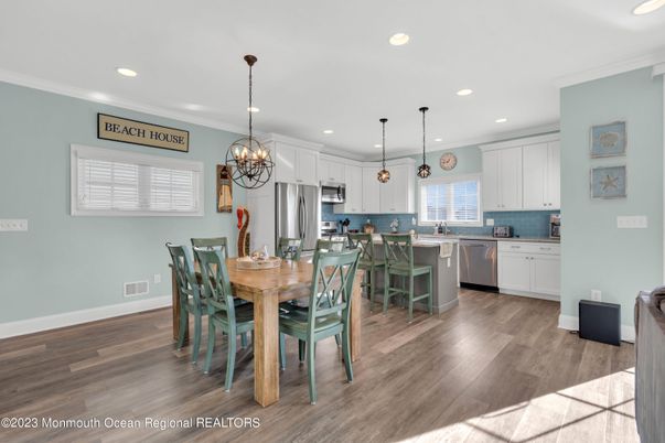 Chandelier, Dining room, Interior, Kitchen, Pendant Lights, Recessed Lighting, Stainless Steel Appliances, Wood Texture Flooring