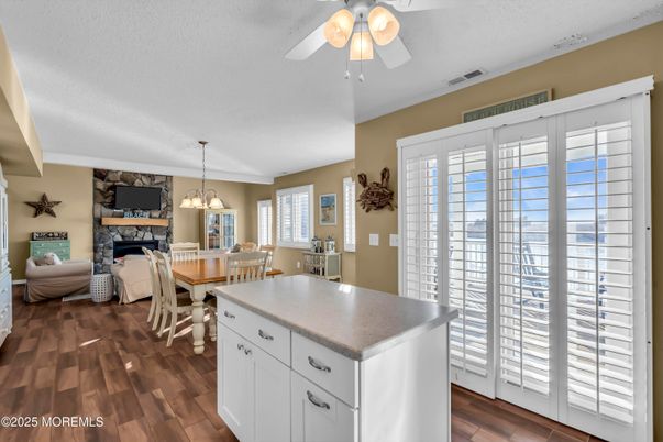 Dining room, Fireplace, Interior, Living room, Pendant Lights, Stone Walls, Wood Texture Flooring