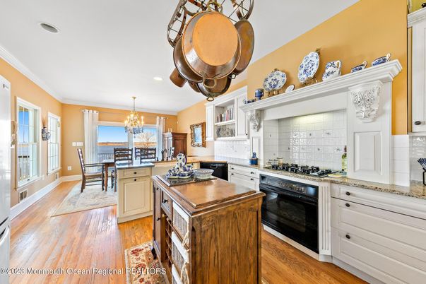 Chandelier, Dining room, Interior, Kitchen, Recessed Lighting, Stainless Steel Appliances, Wood Texture Flooring