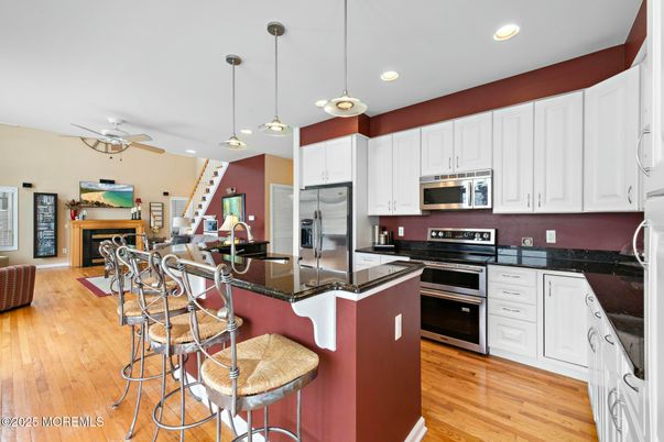 Fireplace, Interior, Kitchen, Pendant Lights, Recessed Lighting, Stainless Steel Appliances, Wood Texture Flooring