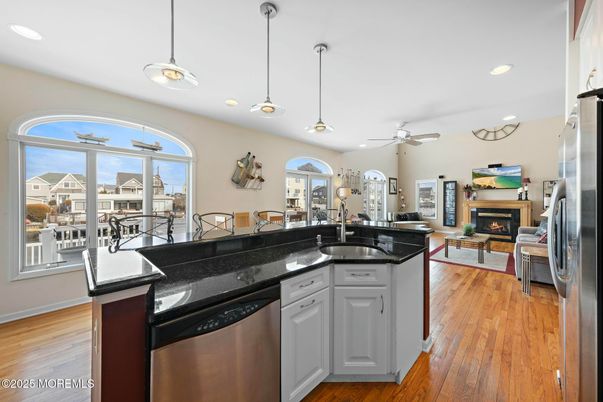 Dining room, Fireplace, Interior, Kitchen, Living room, Pendant Lights, Recessed Lighting, Stainless Steel Appliances, Wood Texture Flooring