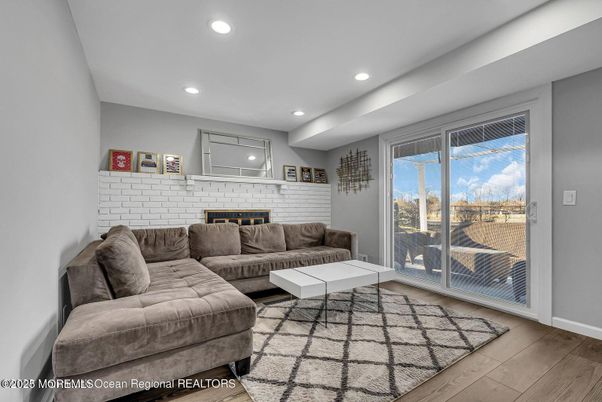Fireplace, Interior, Living room, Recessed Lighting, Stone Walls, Wood Texture Flooring