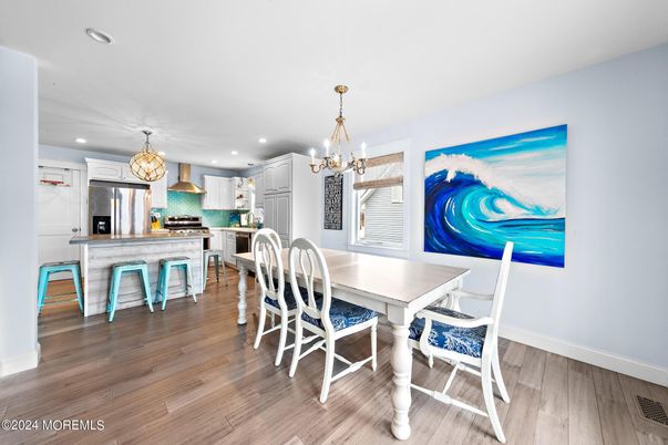 Chandelier, Dining room, Interior, Kitchen, Pendant Lights, Recessed Lighting, Stainless Steel Appliances, Wood Texture Flooring