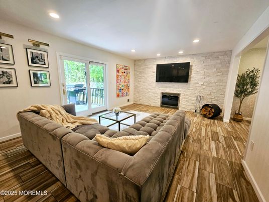 Fireplace, Interior, Living room, Recessed Lighting, Stone Walls, Wood Texture Flooring