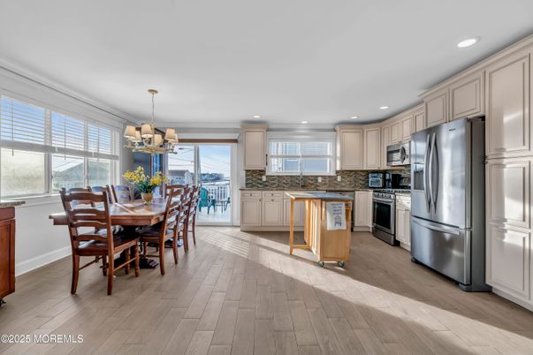 Chandelier, Dining room, Interior, Kitchen, Pendant Lights, Recessed Lighting, Stainless Steel Appliances, Wood Texture Flooring