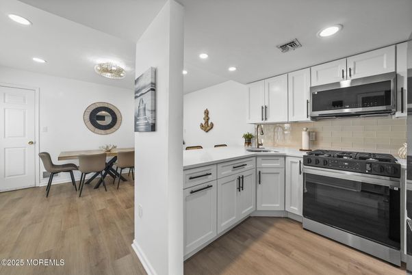 Dining room, Interior, Kitchen, Recessed Lighting, Stainless Steel Appliances, Wood Texture Flooring