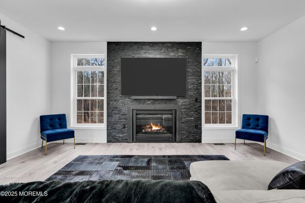 Fireplace, Interior, Living room, Recessed Lighting, Stone Walls, Wood Texture Flooring